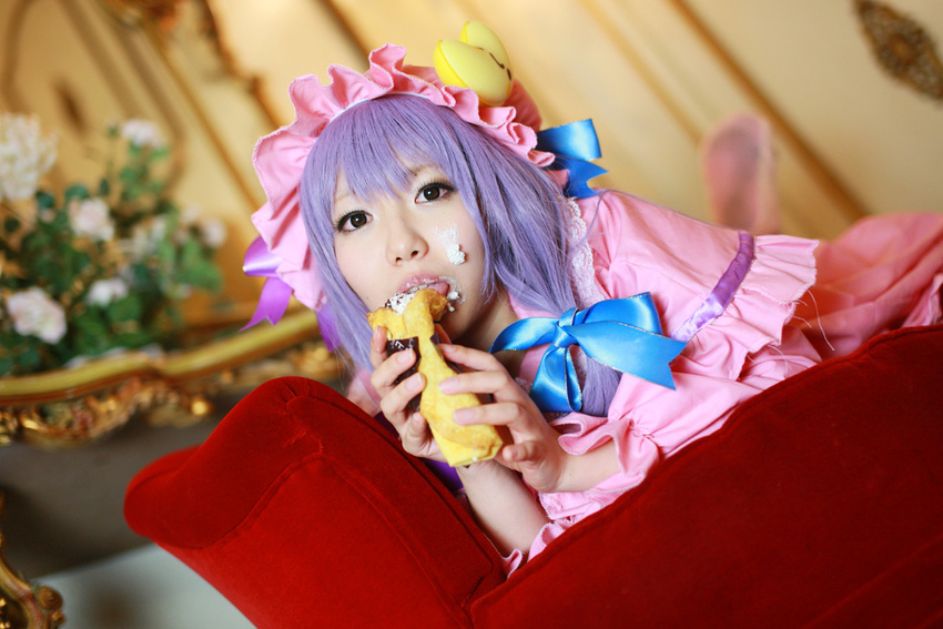1girl asian cosplay couch cream crescent dessert dress female food hat long_hair patchouli_knowledge photo purple_hair solo tenshi_myu touhou