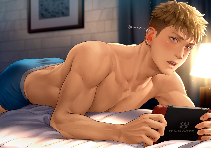 1boy bara blonde_hair blue_male_underwear handheld_game_console holding holding_handheld_game_console hood large_pectorals luca_(mondi_hl) lying male_focus male_underwear mondi_hl muscular muscular_male nintendo_switch on_stomach original pectorals short_hair solo twitter_username underwear