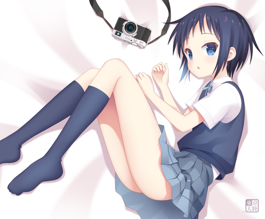 1girl black_hair black_socks blue_eyes blush camera collared_shirt fetal_position full_body highres kneehighs kurasawa_kyoushou kurosaki_honoka looking_at_viewer lying on_side shirt short_hair short_sleeves skirt socks solo vest yama_no_susume