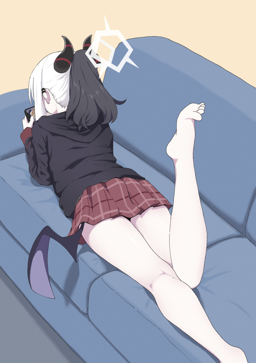 1girl black_hoodie black_horns blue_archive commentary_request couch demon_horns demon_wings ear_piercing grey_halo halo highres hood hoodie horns kayoko_(blue_archive) lying multicolored_hair on_couch on_stomach pale_skin piercing single_wing solo toes two-tone_hair unamaso white_hair wings
