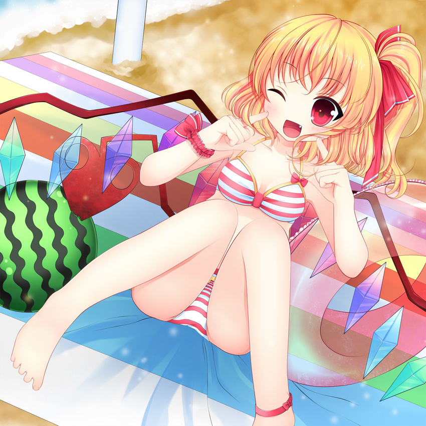 anklet barefoot beach bikini blonde_hair breasts crystal fang flandre_scarlet food fruit highres innertube jewelry laevatein one_eye_closed open_mouth red_eyes sand short_hair side_ponytail small_breasts smile solo swami swimsuit touhou towel water watermelon wings wristband