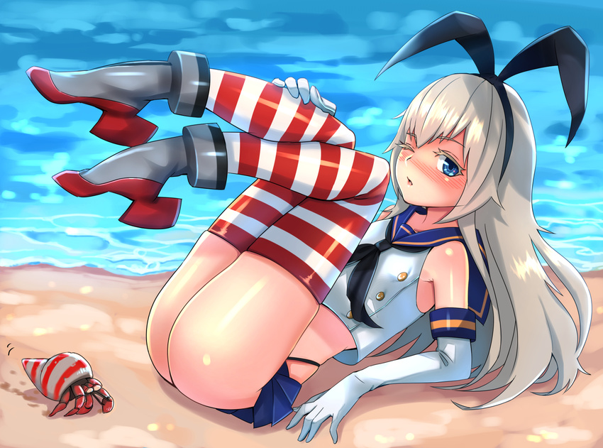 ass bad_id bad_pixiv_id beach blonde_hair blue_eyes elbow_gloves gloves kantai_collection kyuuso_inukami legs_up long_hair looking_at_viewer one_eye_closed outdoors sand shimakaze_(kantai_collection) solo striped striped_legwear thighhighs water