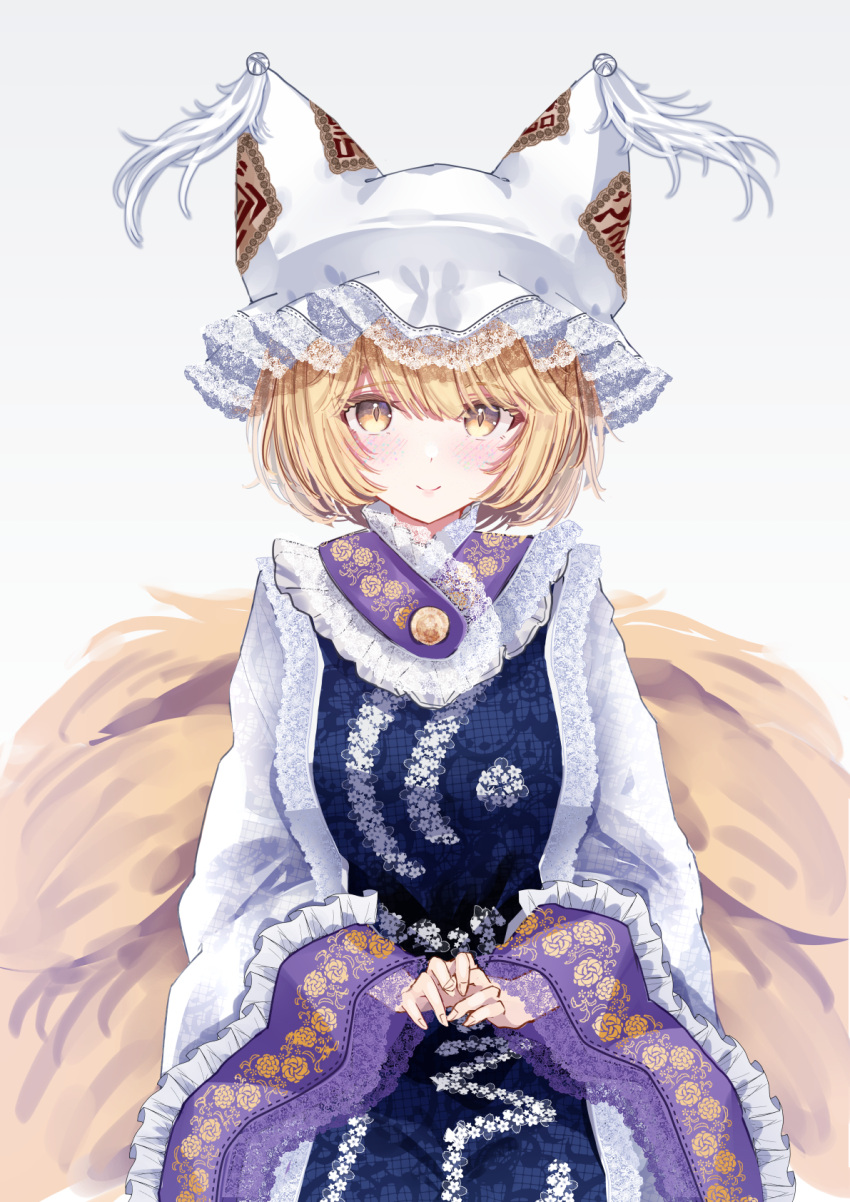 1girl animal_ears blonde_hair blush breasts closed_mouth dress fox_ears fox_tail hat highres large_breasts long_sleeves looking_at_viewer mob_cap multiple_tails sarasadou_dan short_hair simple_background smile solo tabard tail touhou white_background white_dress white_headwear wide_sleeves yakumo_ran yellow_eyes