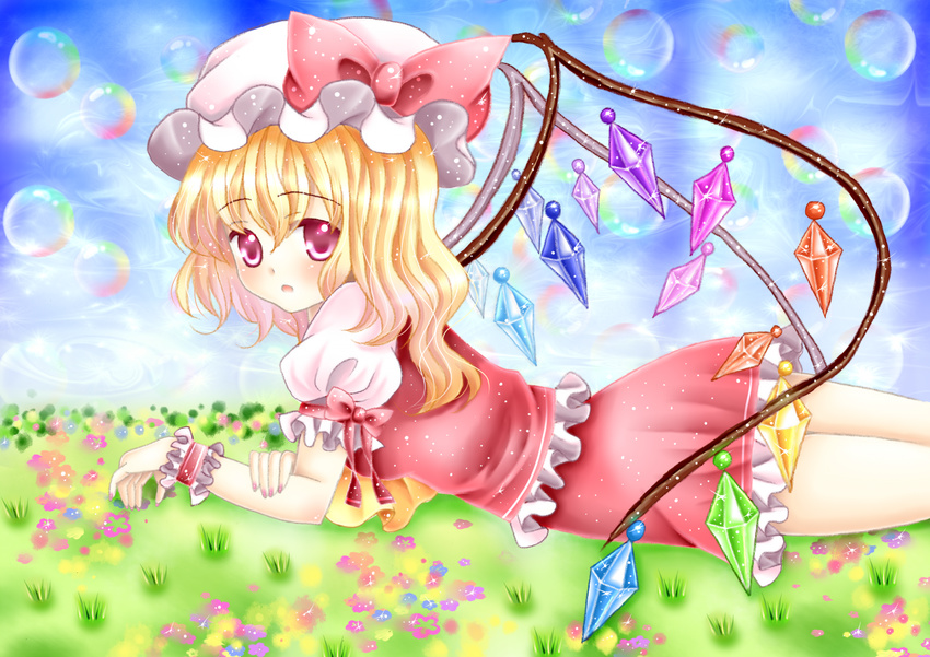 amiguri arm_support ascot blonde_hair blue_sky bubble cloud day flandre_scarlet flower grass hat hat_ribbon highres holding_arm light_particles looking_at_viewer lying mob_cap on_stomach open_mouth outdoors puffy_short_sleeves puffy_sleeves red_eyes ribbon short_hair short_sleeves side_ribbon skirt skirt_set sky solo sparkle touhou wings wrist_cuffs