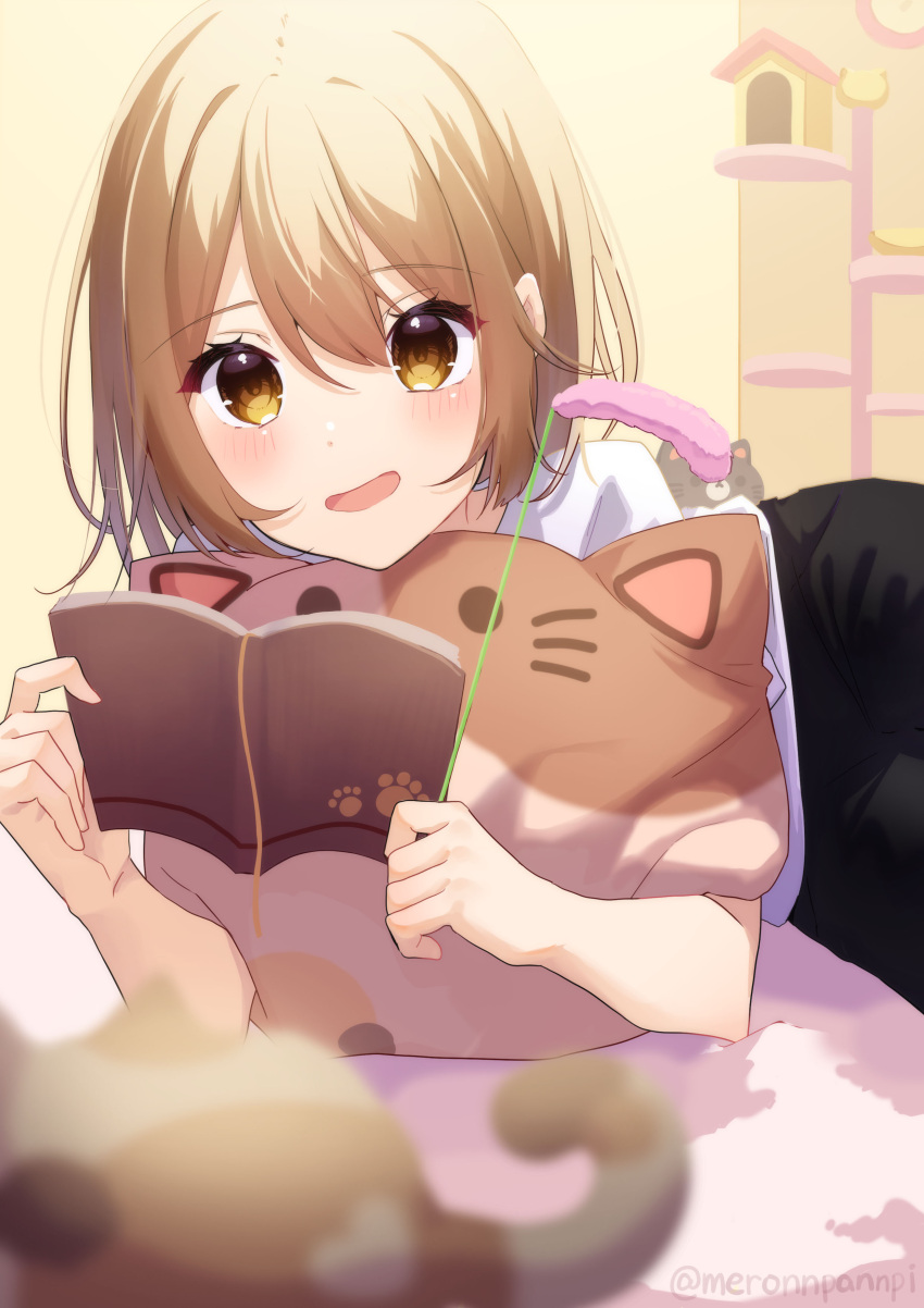 1girl absurdres animal blurry blurry_foreground blush book brown_eyes brown_hair cat cat_teaser cat_tower highres holding holding_book indoors long_hair lying meronnpannpi on_side open_mouth original pantyhose short_sleeves shorts smile solo stuffed_animal stuffed_cat stuffed_toy
