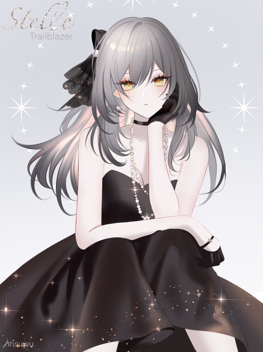 1girl 707arisu artist_name bare_shoulders black_choker black_dress black_gloves black_ribbon blush breasts character_name choker closed_mouth dress expressionless eyeliner feet_out_of_frame formal gloves grey_hair hair_between_eyes hair_ribbon half_gloves hand_on_own_cheek hand_on_own_face head_rest highres honkai:_star_rail honkai_(series) jewelry knees_together_feet_apart long_hair looking_at_viewer makeup medium_breasts necklace red_eyeliner ribbon simple_background sitting solo stelle_(honkai:_star_rail) straight-on strapless strapless_dress trailblazer_(honkai:_star_rail) white_background yellow_eyes