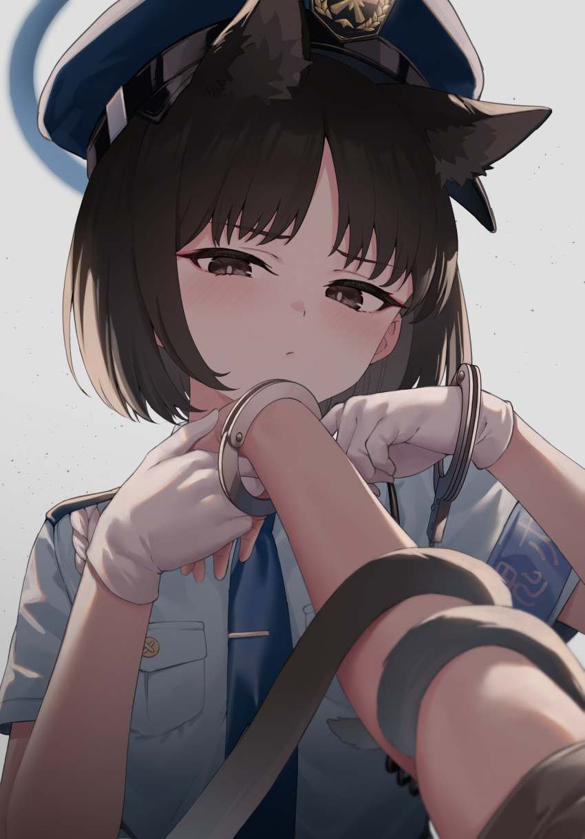 1girl 1other absurdres animal_ears black_eyes black_hair blue_archive blue_headwear blue_necktie blue_shirt blush cat_ears cat_tail closed_mouth collared_shirt cuffs gloves hat highres kikyou_(blue_archive) looking_at_viewer multiple_tails necktie pizza_(pizzania_company) police police_hat police_uniform policewoman shackles shirt short_hair short_sleeves tail two_tails uniform upper_body white_gloves