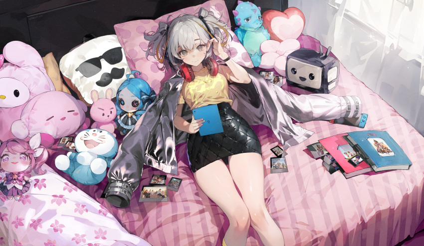 1girl absurdres ayumeyatto black_bow black_ribbon black_skirt black_wristband book borrowed_character bow character_doll grey_eyes grey_hair grey_jacket hair_ribbon headphones headphones_around_neck heart heart_pillow high-waist_skirt highres holding holding_tablet_pc jacket jacket_on_shoulders on_bed open_clothes open_jacket original pillow polaroid ribbon shirt skirt solo stuffed_dinosaur tablet_pc yellow_shirt