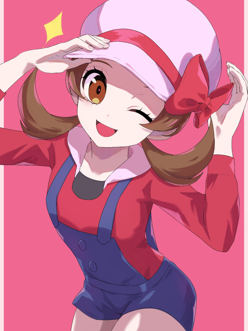 1girl ;d blue_overalls bow brown_eyes brown_hair commentary_request cowboy_shot dusk_poke27 eyelashes hands_up hat hat_bow highres long_hair looking_at_viewer lyra_(pokemon) one_eye_closed open_mouth overalls pink_background pokemon pokemon_hgss red_bow red_shirt shirt simple_background smile solo twintails