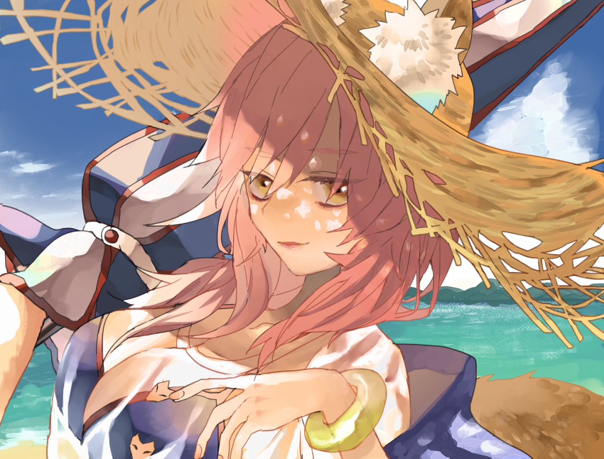 1girl animal_ear_fluff animal_ears beach bikini blue_bikini breasts cleavage cloud day ears_through_headwear emasrrkn fate/extra fate/grand_order fate_(series) fox_ears fox_tail hat highres holding holding_umbrella large_breasts long_hair looking_at_viewer outdoors pink_hair smile solo straw_hat swimsuit tail tamamo_(fate) tamamo_no_mae_(fate/extra) tamamo_no_mae_(swimsuit_lancer)_(fate) umbrella yellow_eyes
