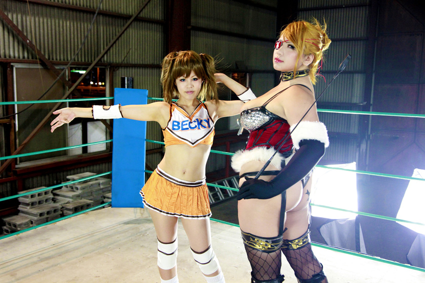 arena ass blonde_hair boxing_ring breasts brown_hair chouzuki_maryou cleavage cosplay eyepatch fingerless_gloves gloves huge_ass mistress_spencer mistress_spencer_(cosplay) multiple_girls photo rebecca_welsh rebecca_welsh_(cosplay) rumble_roses rumble_roses_xx suzuka_itsuki whip