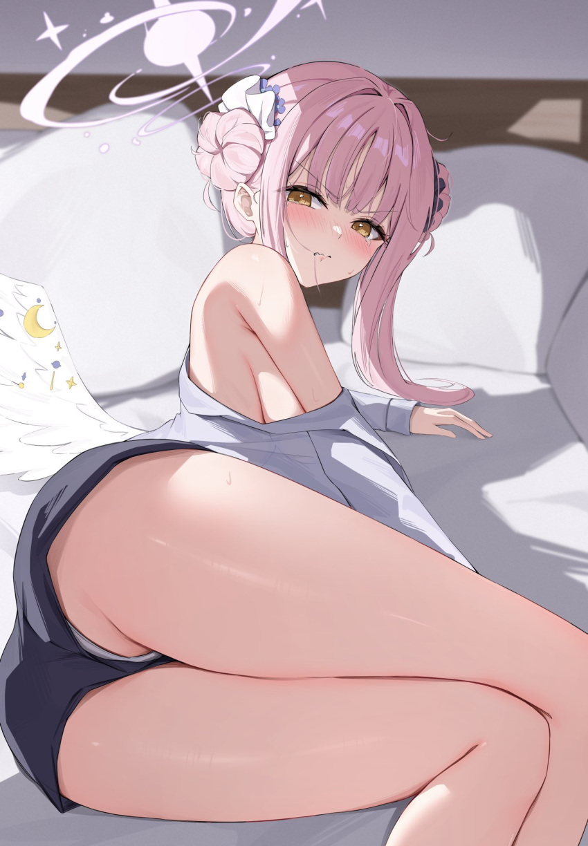1girl angel_wings ass bed bed_sheet black_shorts blue_archive blush crescent crescent_pin double_bun feathered_wings feet_out_of_frame grey_shirt hair_bun halo highres indoors long_hair long_sleeves looking_at_viewer mika_(blue_archive) nenight pillow pink_hair pink_halo shirt shorts solo white_wings wings yellow_eyes