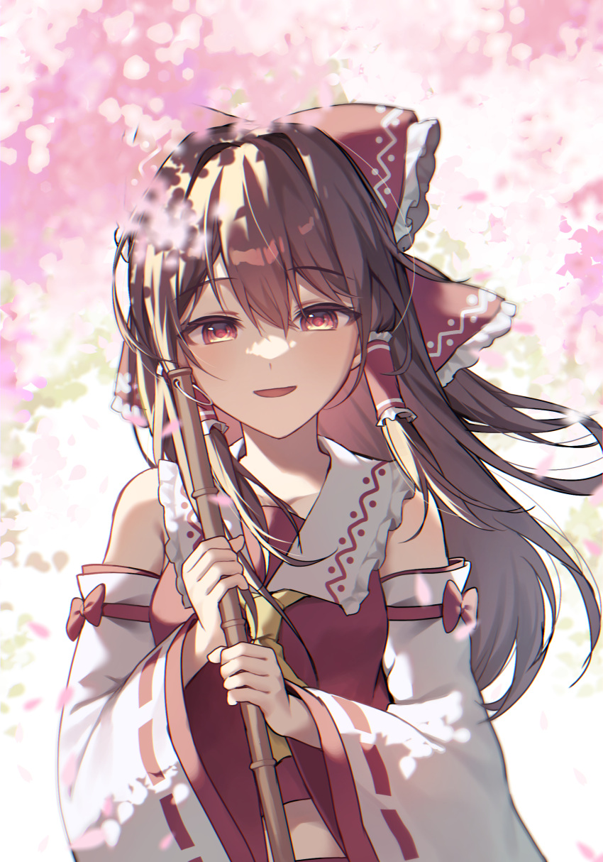 1girl absurdres ascot bow broom brown_eyes brown_hair cherry_blossoms commentary detached_sleeves frilled_bow frilled_hair_tubes frills hair_bow hair_tubes hakurei_reimu highres holding holding_broom kurobikari long_hair looking_at_viewer open_mouth red_bow ribbon-trimmed_sleeves ribbon_trim smile solo touhou yellow_ascot