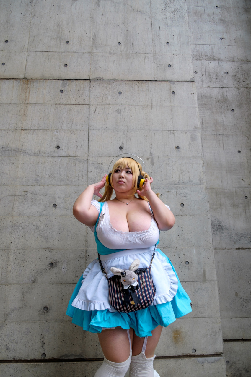 1girl asian blonde_hair breasts brown_eyes cleavage cosplay fat headphones hoshima_mika huge_breasts jewelry necklace nitroplus photo solo star super_pochaco super_pochaco_(cosplay) twintails