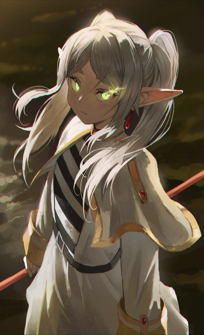 1girl belt capelet closed_mouth commentary dotthebot drop_earrings earrings elden_ring elf eyelashes frieren glowing glowing_eyes gold_trim green_eyes highres jewelry long_hair parted_bangs pointy_ears solo sousou_no_frieren standing thick_eyebrows twintails white_capelet white_hair