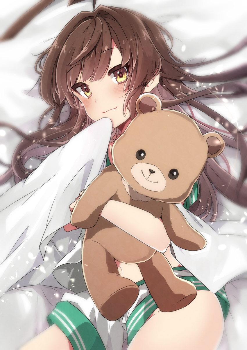 ahoge belly_peek blanket blush brown_eyes brown_hair commentary_request cowboy_shot hand_to_own_mouth highres hips hug kantai_collection kuma_(kantai_collection) long_hair looking_at_viewer lying navel object_hug on_back pillow school_uniform serafuku short_shorts shorts smile solo sparkle stuffed_animal stuffed_toy takeshima_(nia) teddy_bear
