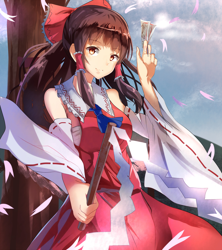 ascot bare_shoulders bow brown_eyes brown_hair cloud cloudy_sky day detached_sleeves dress gohei hair_bow hair_tubes hakurei_reimu highres hizagawa_rau long_hair long_sleeves looking_at_viewer petals red_bow red_dress sarashi sky smile solo spell_card touhou tree wide_sleeves