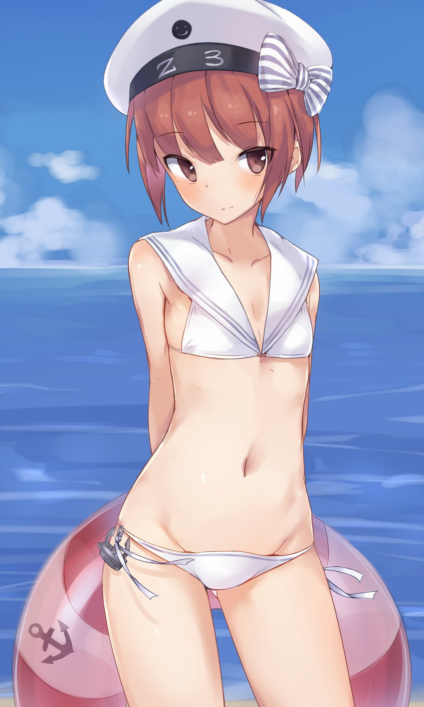 anchor_symbol arms_behind_back bare_arms bare_shoulders beret bikini blue_sky blush bow brown_eyes character_name clothes_writing cloud collarbone contrapposto cowboy_shot day eyebrows eyebrows_visible_through_hair flat_chest hat hat_bow hat_ornament highres holding horizon innertube kantai_collection looking_at_viewer metindone ocean sailor_bikini sailor_collar short_hair side-tie_bikini sky smile smiley_face solo standing striped striped_bow swimsuit water white_hat z3_max_schultz_(kantai_collection)