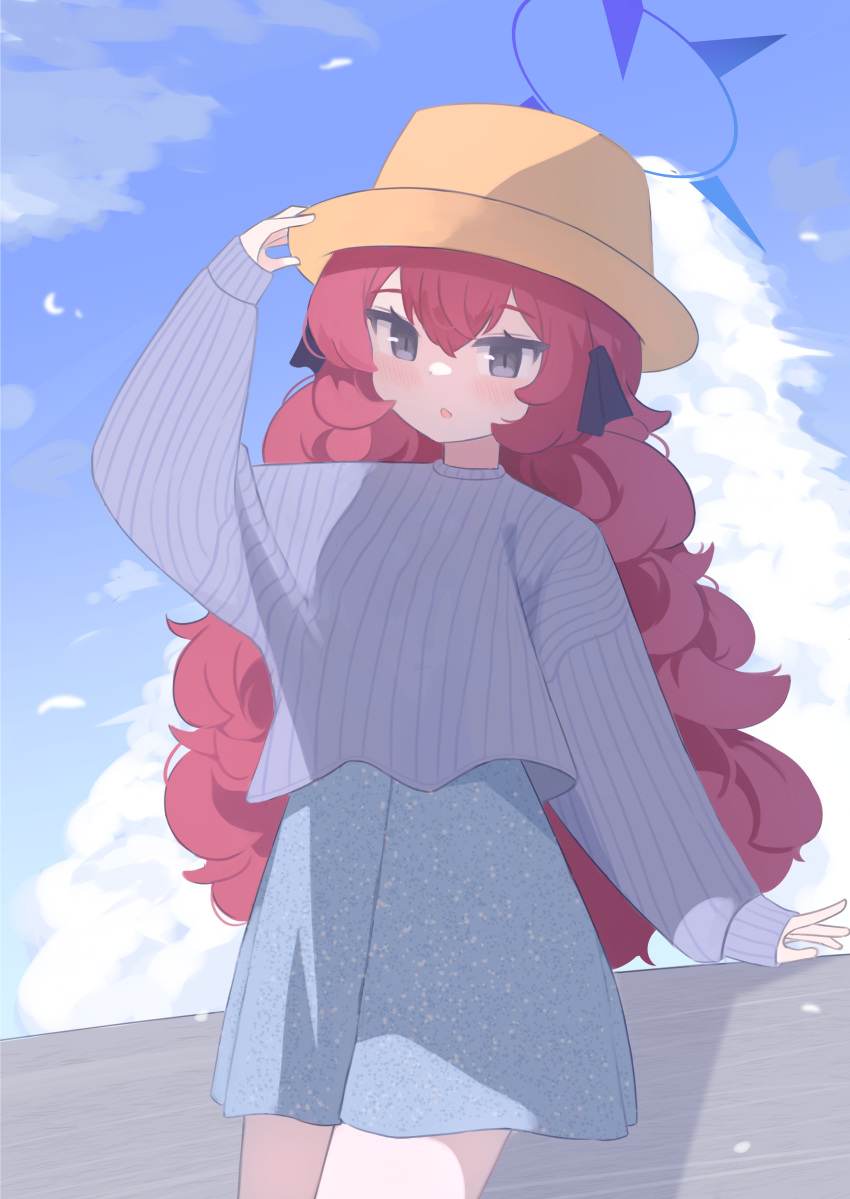 1girl absurdres anma21 blue_archive blue_halo blue_skirt blue_sky blue_sweater blush cloud cowboy_shot cropped_sweater day grey_eyes hair_between_eyes halo hand_on_headwear hat highres iroha_(blue_archive) long_hair long_sleeves outdoors parted_lips red_hair skirt sky solo sweater wavy_hair
