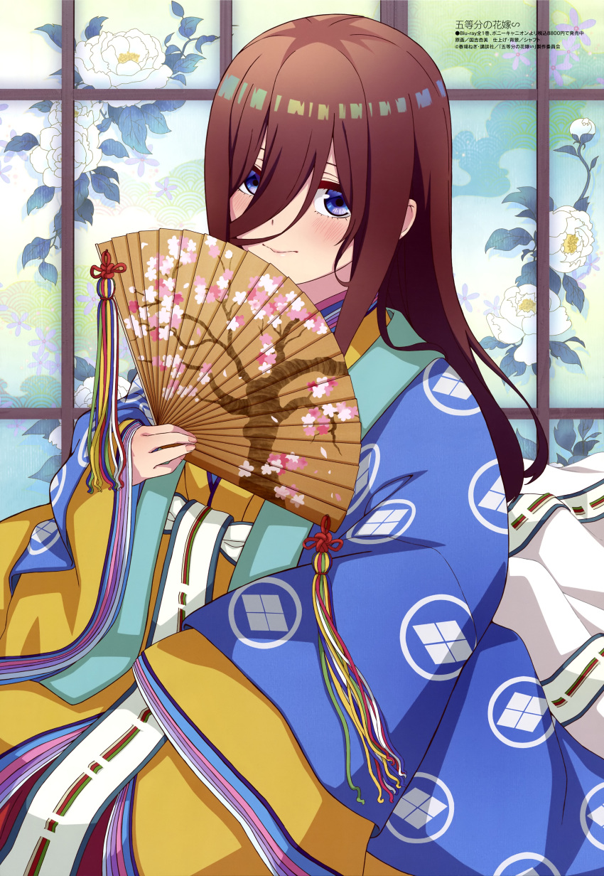 1girl absurdres blue_eyes blush brown_hair closed_mouth go-toubun_no_hanayome hair_between_eyes hand_fan highres holding holding_fan japanese_clothes kimono long_hair looking_at_viewer megami_magazine multicolored_clothes multicolored_kimono nakano_miku official_art paper_fan scan smile solo tassel wide_sleeves