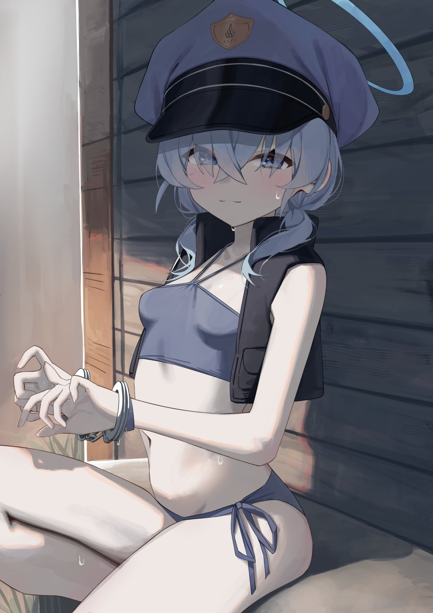 1girl absurdres bare_arms bikini black_vest blue_archive blue_bikini blue_eyes blue_hair blue_hat blush bound bound_wrists breasts closed_mouth commentary_request cuffs eyes_visible_through_hair hair_between_eyes hair_over_eyes halo halterneck handcuffs hat highres light_smile looking_ahead looking_at_viewer low_twintails medium_hair navel open_clothes open_vest peaked_cap police_hat revision side-tie_bikini_bottom sitting small_breasts solo sweat swimsuit syhan twintails valkyrie_police_academy_student_(blue_archive) valkyrie_police_academy_student_(sg)_(blue_archive) vest