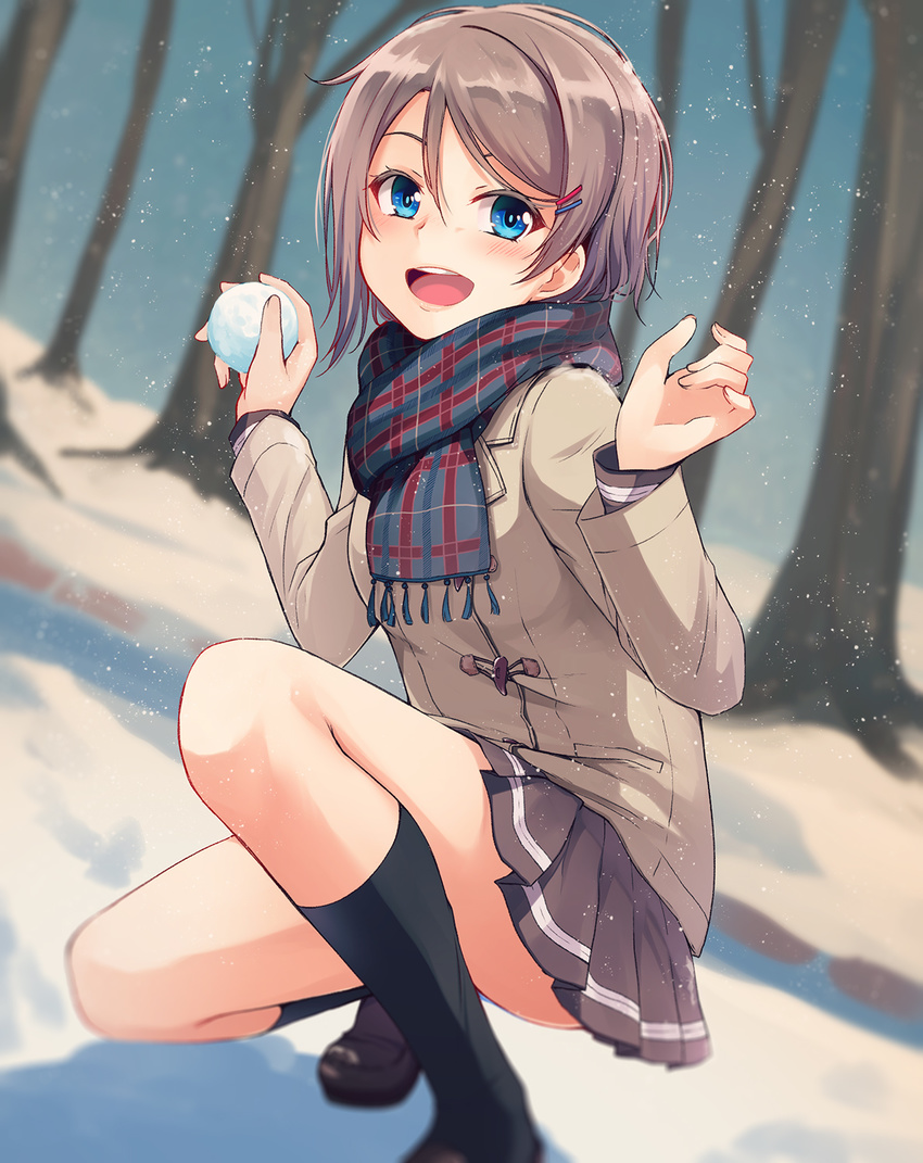 :d black_legwear blue_eyes blurry blush brown_hair coat depth_of_field hair_ornament hairclip highres kneehighs loafers looking_at_viewer love_live! love_live!_sunshine!! nanotsuki open_mouth outdoors pleated_skirt round_teeth scarf shoes short_hair skirt smile snow snowball snowball_fight snowing solo squatting teeth tree watanabe_you winter winter_clothes winter_coat