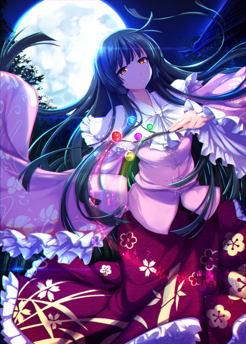 backlighting bamboo bamboo_forest black_hair blouse branch closed_mouth commentary_request cowboy_shot floral_print forest full_moon highres hime_cut houraisan_kaguya japanese_clothes jeweled_branch_of_hourai long_hair long_skirt long_sleeves looking_at_viewer moon moonlight nature night orange_eyes ouma_tokiichi outdoors pink_blouse print_skirt red_skirt skirt sleeves_past_wrists smile solo touhou very_long_hair wide_sleeves
