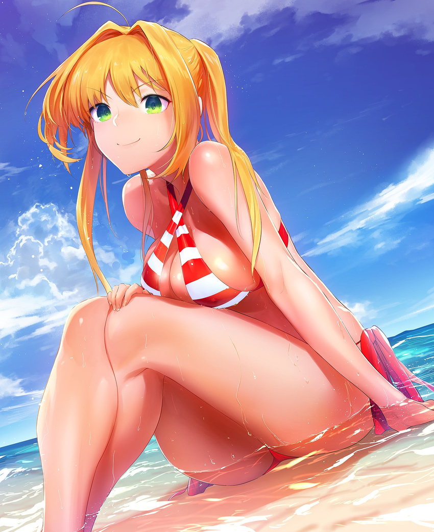 ahoge bare_shoulders beach bikini blonde_hair breasts cloud covered_nipples criss-cross_halter crossed_legs day fate/grand_order fate_(series) green_eyes hair_intakes halterneck highres horizon large_breasts nero_claudius_(fate)_(all) nero_claudius_(swimsuit_caster)_(fate) outdoors partially_submerged ryokucha_(i_cobalt) sand side-tie_bikini sitting sky smile striped striped_bikini swimsuit twintails water wet