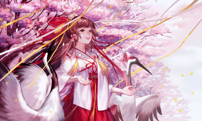 :d alternate_costume bangs bird blunt_bangs bow brown_hair cherry_blossoms confetti cowboy_shot crane_(animal) cross-laced_clothes eyebrows_visible_through_hair hair_bow hair_tubes hakama hakurei_reimu happy highres japanese_clothes kimono long_hair long_sleeves looking_away open_mouth outdoors pom_pom_(clothes) red-crowned_crane red_bow red_eyes red_hakama round_teeth smile solo spring_(season) standing tassel teeth touhou tree wei_li wide_sleeves