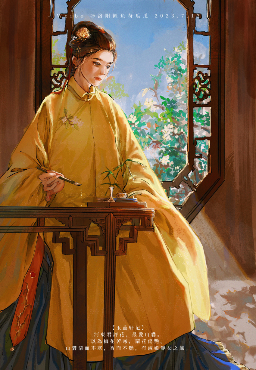 1girl brown_hair calligraphy calligraphy_brush chinese_clothes chinese_empire chinese_text hair_ornament hanfu highres liu_rushi luoyang_liyufu_guagua ming_dynasty original paintbrush qing_dynasty sitting solo table weibo_username window yellow_hanfu