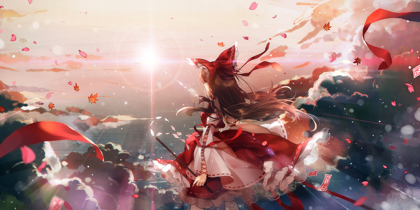 arm_ribbon bangs bow breasts brown_hair cloud cowboy_shot day detached_sleeves floating_hair frilled_bow frills from_behind gohei hair_bow hakurei_reimu highres holding leaf lens_flare light_particles light_rays light_trail long_hair long_skirt looking_afar outdoors petals red_bow red_eyes red_ribbon red_shirt red_skirt ribbon ribbon-trimmed_skirt ribbon-trimmed_sleeves ribbon_trim rokusai shiny shiny_hair shirt skirt small_breasts solo sun sunbeam sunlight talisman touhou very_long_hair wide_sleeves wind