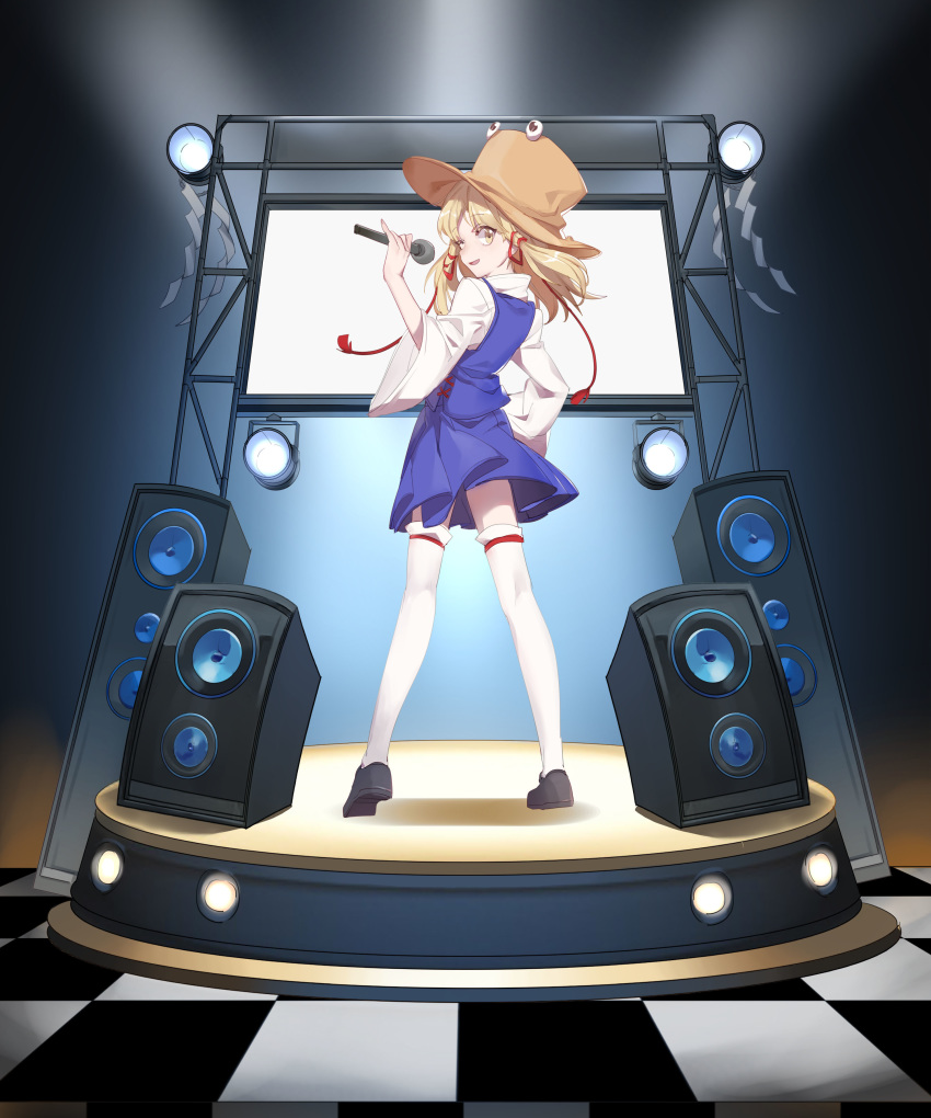 1girl absurdres aibivy black_footwear blonde_hair blue_skirt blue_vest brown_hat checkered checkered_floor from_behind hair_ribbon hand_on_hip hat highres holding holding_microphone legs_apart long_hair looking_at_viewer looking_back microphone miniskirt moriya_suwako red_ribbon ribbon shide shirt shoes skirt skirt_set smile solo speaker stage standing thighhighs touhou tress_ribbon vest white_legwear white_shirt wide_sleeves yellow_eyes