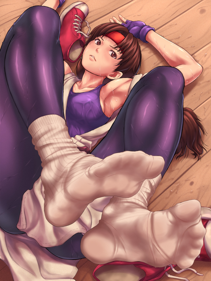 armpits bangs breasts brown_eyes brown_hair commentary_request covered_nipples dougi feet fingerless_gloves foreshortening gloves headband highres lips long_hair looking_at_viewer lying maku_(l-u) medium_breasts on_back parted_bangs parted_lips purple_gloves purple_legwear red_footwear red_headband ribbed_legwear shoes shoes_removed sneakers socks socks_removed soles solo spandex sweat the_king_of_fighters white_legwear wooden_floor yuri_sakazaki