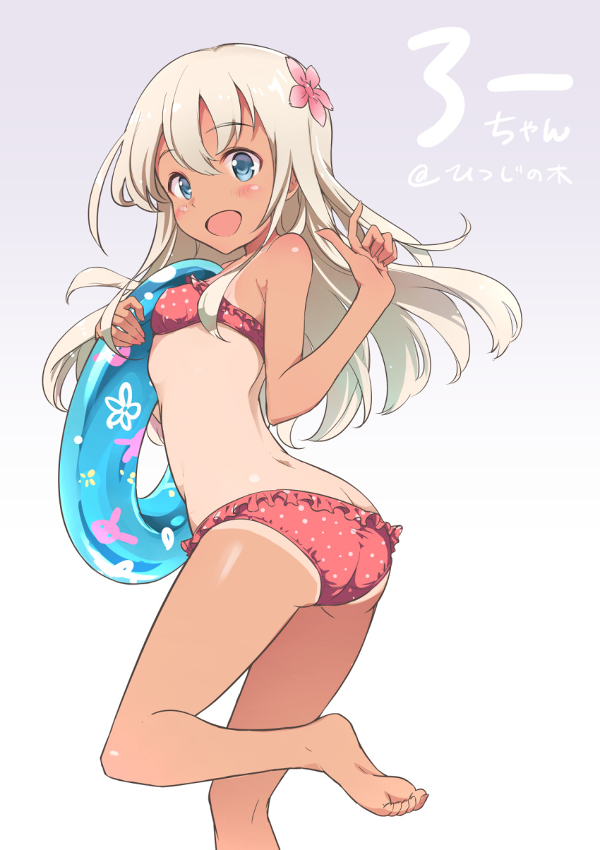 arm_up ass back bikini blue_eyes blue_innertube blush bunny commentary flower hair_flower hair_ornament highres holding innertube kantai_collection leg_up legs long_hair moupii_(hitsuji_no_ki) one-piece_tan open_mouth pink_swimsuit polka_dot ro-500_(kantai_collection) smile solo swimsuit tan tanline white_hair