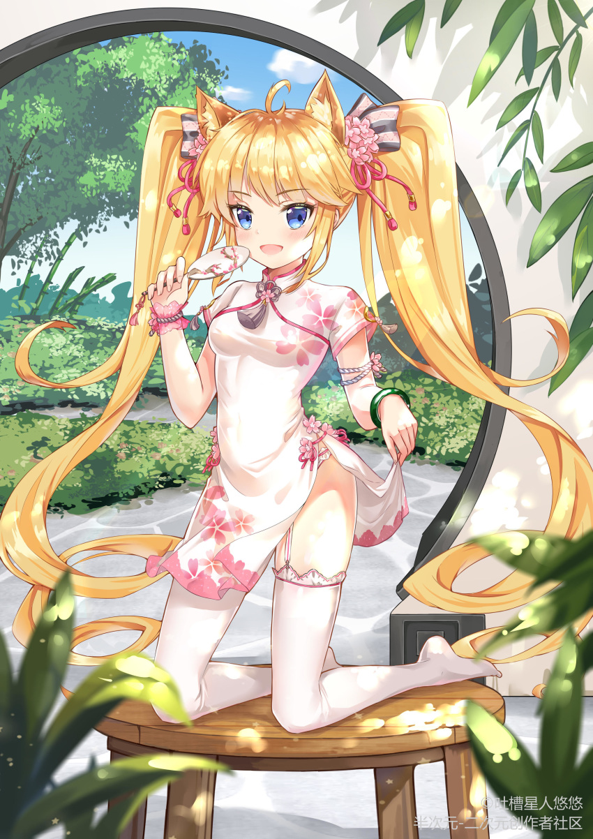 absurdres andrea_doria_(zhan_jian_shao_nyu) animal_ears bamboo blonde_hair blue_eyes breasts cat_ears china_dress chinese_clothes dress fan full_body hair_ornament highres kneeling long_hair looking_at_viewer no_shoes plant skirt_hold small_breasts solo table thighhighs tree twintails zhan_jian_shao_nyu