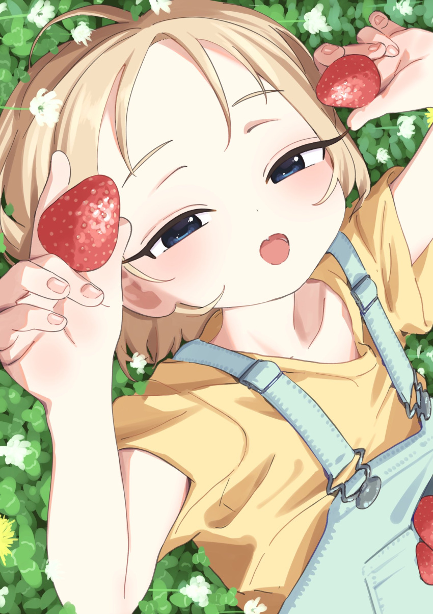 1girl blonde_hair blue_eyes blush bouen clover denim flower food fruit highres holding holding_food holding_fruit looking_at_viewer lying on_back open_mouth orange_shirt original overalls shirt short_hair short_sleeves solo strawberry upper_body white_flower