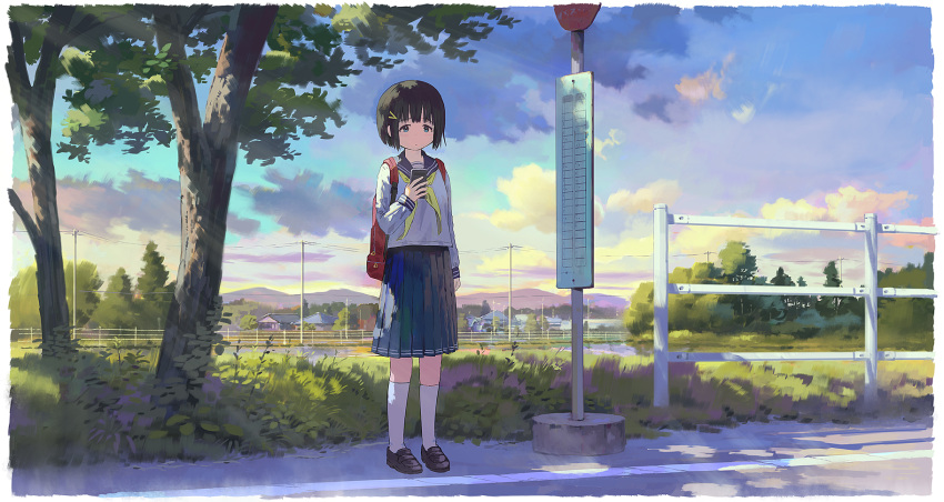 1girl backpack bag black_footwear black_hair blue_eyes blue_sailor_collar blue_skirt blue_sky bus_stop cellphone closed_mouth cloud commentary_request dot_mouth feel_(nasitaki) field full_body grass hair_ornament hairclip highres holding holding_phone house morning mountainous_horizon original outdoors phone pleated_skirt power_lines railing red_bag road road_sign sailor_collar scenery shirt short_hair sign skirt sky smartphone socks solo standing tree white_shirt white_socks