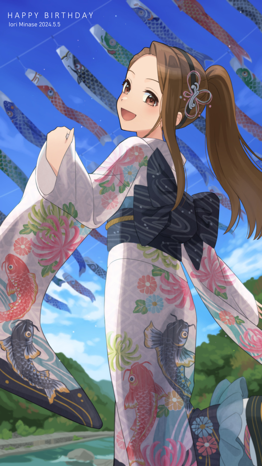 1girl :d animal_print asymmetrical_bangs black_hairband blue_sky blush brown_hair character_name cloud cloudy_sky dated dot_nose fish_print floral_print_kimono forehead from_behind fukakuteisei hair_ornament hairband happy_birthday highres idolmaster idolmaster_(classic) idolmaster_million_live! idolmaster_million_live!_theater_days japanese_clothes kimono koinobori long_hair long_sleeves looking_at_viewer looking_back minase_iori obi obijime official_alternate_hairstyle open_mouth outdoors ponytail print_kimono river sash single_sidelock sky smile solo standing tree windsock