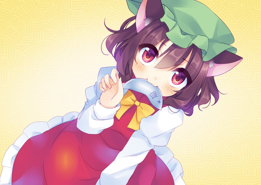 1girl :3 animal_ears blush bow brown_hair cat_ears chen eyebrows_visible_through_hair fish fish_in_mouth frilled_hat frilled_skirt frills green_headwear hair_between_eyes hat highres kujou_mikuru long_sleeves looking_at_viewer looking_up mob_cap nekomata no_tail patterned_background red_eyes red_skirt red_vest shirt short_hair skirt skirt_set solo touhou vest white_shirt x_x yellow_background yellow_bow yellow_neckwear