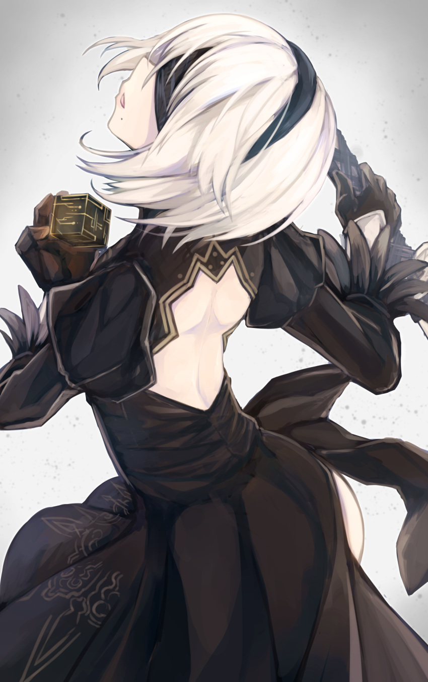 1girl ass back back_cutout bangs black_blindfold black_dress black_gloves black_hairband blindfold covered_eyes cube dress facing_away feather-trimmed_sleeves from_behind gloves grey_background hairband head_tilt highres holding holding_sword holding_weapon juliet_sleeves long_sleeves mole mole_under_mouth nier_(series) nier_automata otogi_kyouka parted_lips puffy_sleeves short_hair silver_hair solo sword vambraces weapon yorha_no._2_type_b