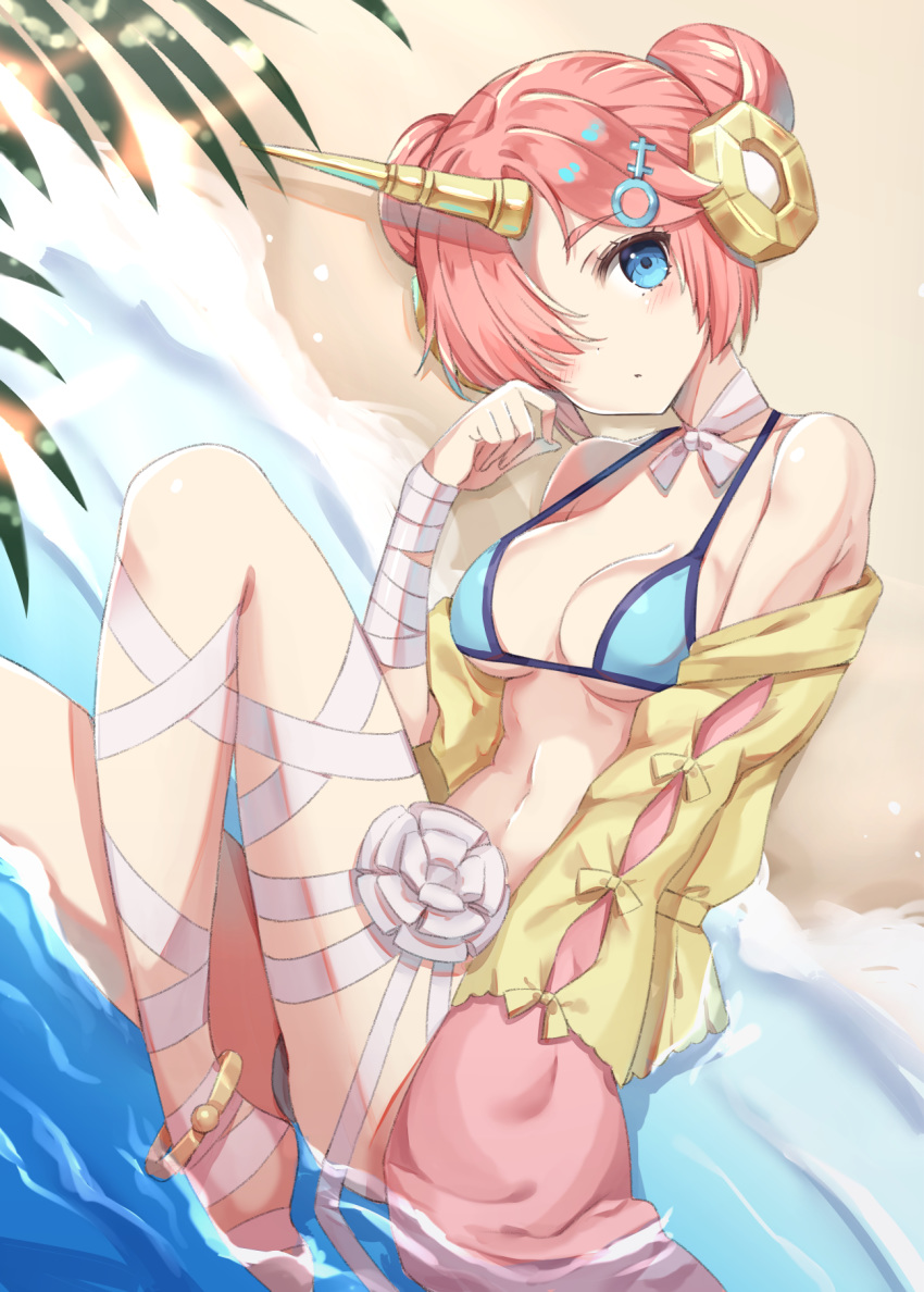 1girl bandaged_arm bandaged_leg bandages beach bikini blue_bikini blue_eyes blush breasts cleavage closed_mouth collarbone commentary_request day double_bun fate/grand_order fate_(series) frankenstein's_monster_(fate) frankenstein's_monster_(swimsuit_saber)_(fate) hair_ornament hair_over_one_eye hand_up highres horn jacket knee_up looking_at_viewer lying medium_breasts navel on_side open_clothes open_jacket outdoors palm_tree pink_hair sand solo swimsuit tree water yellow_jacket yuzu-aki