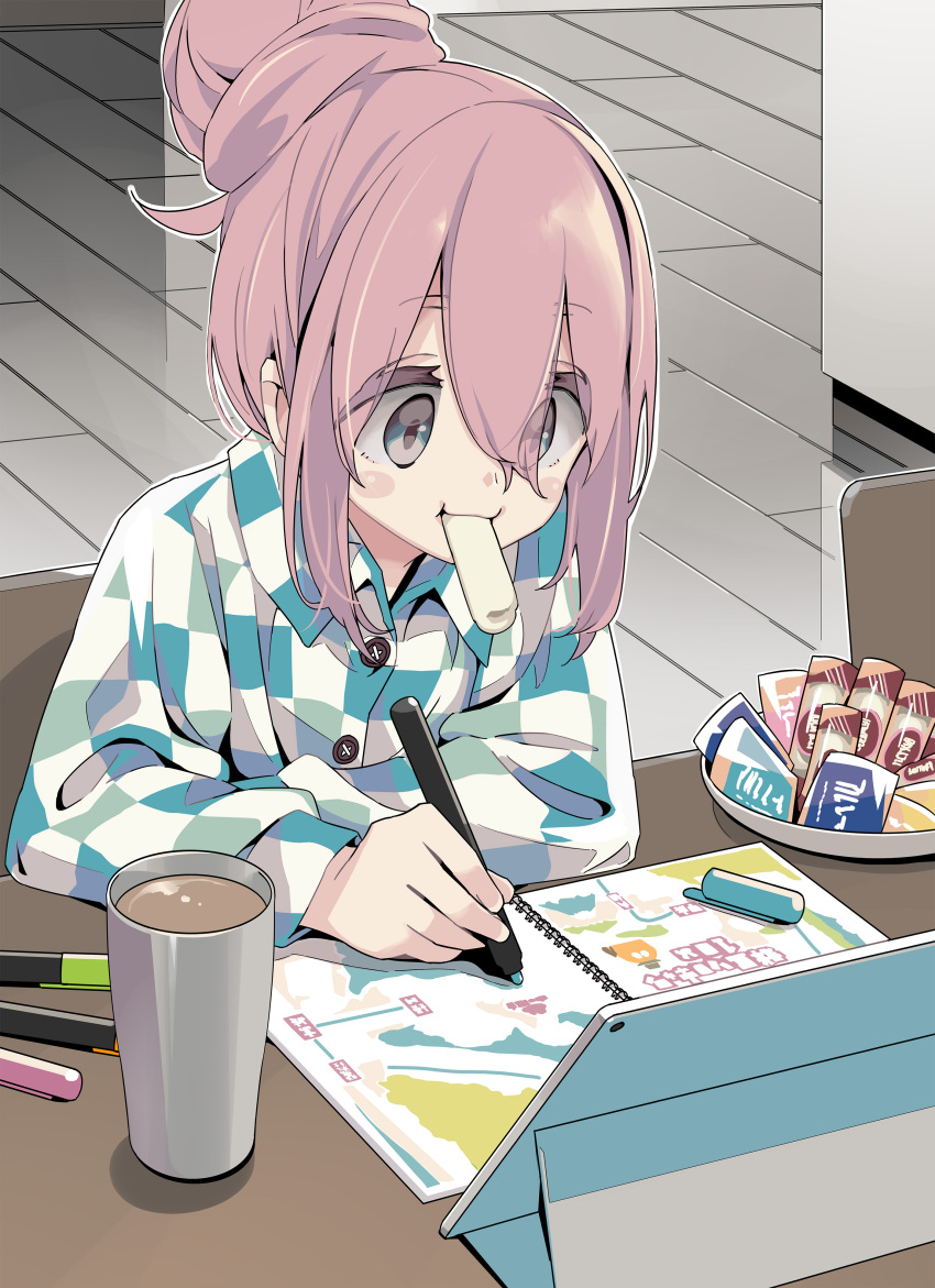 1girl absurdres afro_(kngotezo) blue_eyes chair checkered_clothes checkered_shirt commentary_request cup drawing_(object) eating hair_bun highres kagamihara_nadeshiko long_hair long_sleeves pink_hair shirt single_hair_bun snack solo table upper_body yurucamp