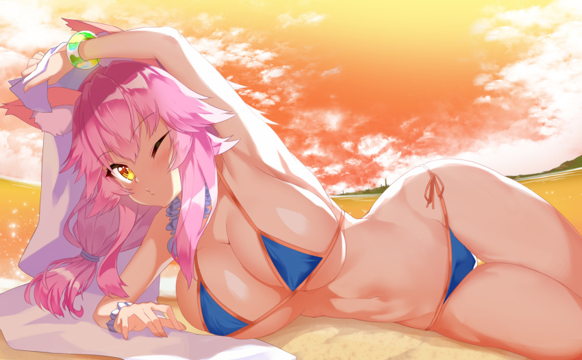 1girl alternate_costume animal_ear_fluff animal_ears armpits backlighting bare_shoulders bikini blue_bikini blush breasts cleavage cloud cloudy_sky collarbone evening eyebrows_visible_through_hair fate/grand_order fate_(series) fox_ears fox_girl groin hair_between_eyes large_breasts long_hair looking_at_viewer lying messy_hair micro_bikini navel no_tail ocean on_side one_eye_closed open_mouth pink_hair pouty_lips side-tie_bikini sideboob sky solo stomach swimsuit tamamo_(fate)_(all) tamamo_no_mae_(fate) tamamo_no_mae_(swimsuit_lancer)_(fate) thighs towel underboob water wrist_cuffs yellow_eyes yuruto