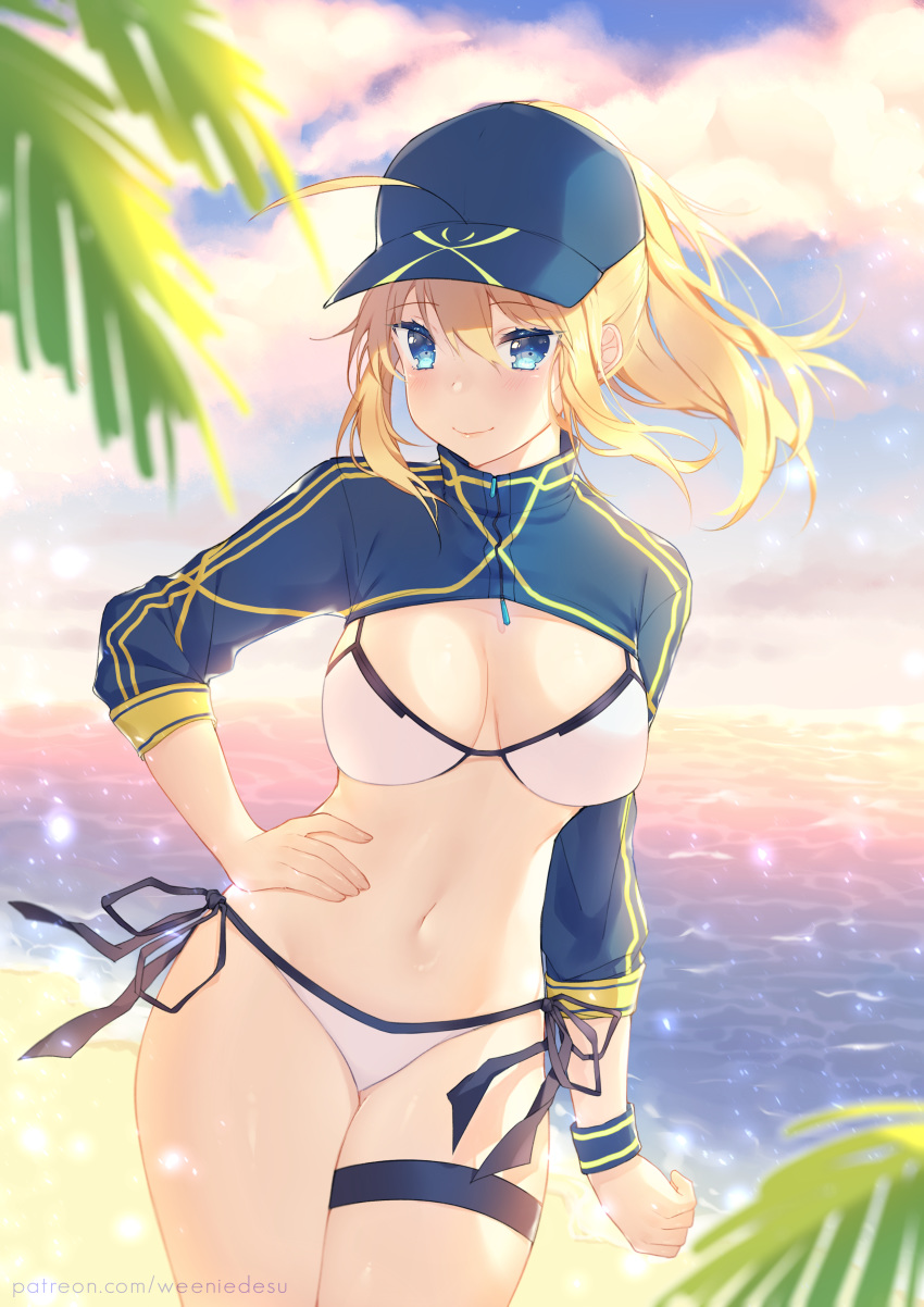 1girl absurdres ahoge artoria_pendragon_(all) baseball_cap beach bikini blonde_hair blue_eyes blue_headwear blue_jacket breasts cloud cowboy_shot cropped_jacket evening fate/grand_order fate_(series) hair_between_eyes hair_through_headwear hand_on_hip hat highres jacket large_breasts mysterious_heroine_xx_(foreigner) navel outdoors ponytail shrug_(clothing) side-tie_bikini smile solo standing swimsuit thigh_strap weeniedesu white_bikini wristband zipper_pull_tab