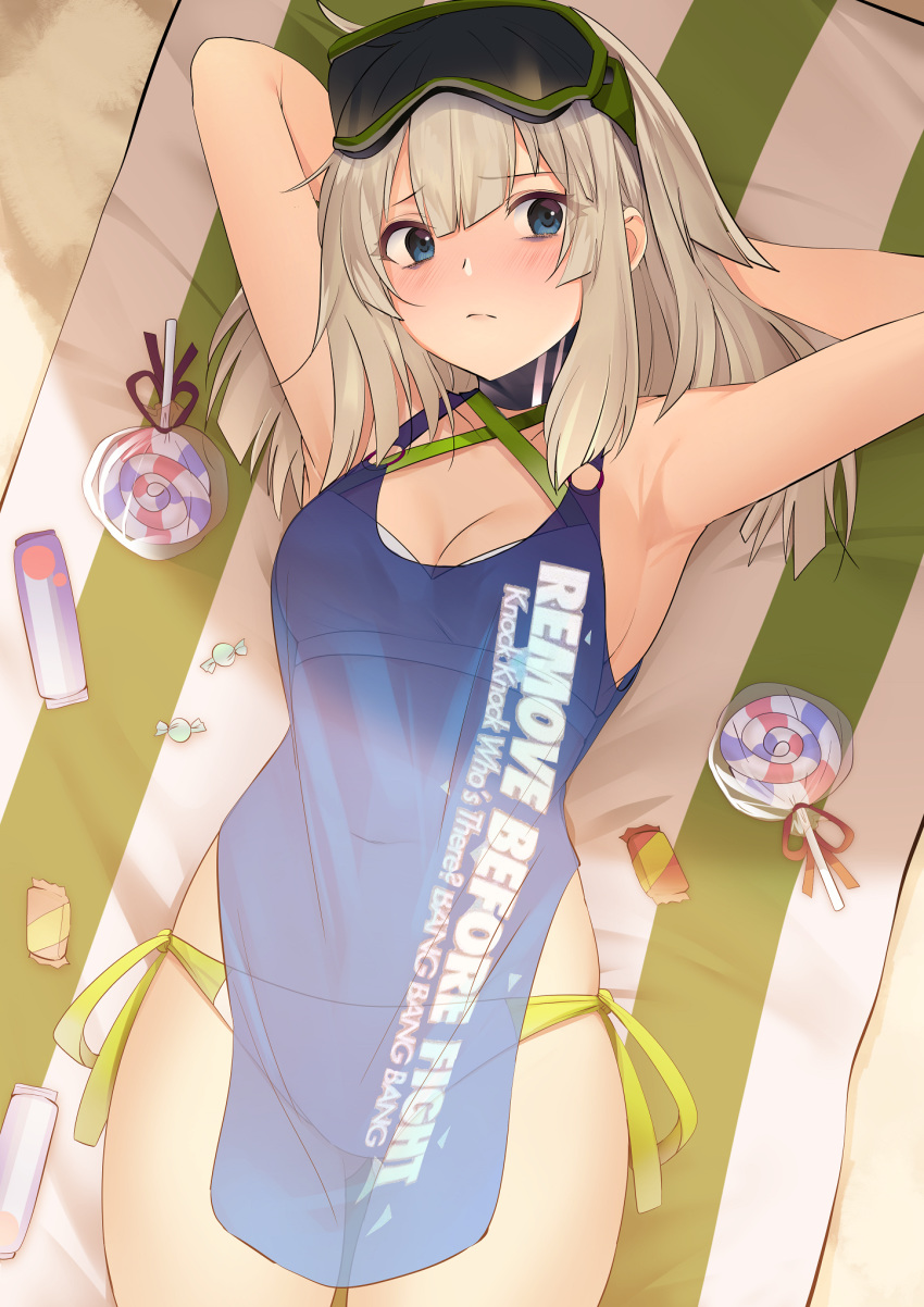 1girl aa-12_(girls_frontline) armpits arms_up ass_visible_through_thighs bangs bare_shoulders beach_towel bikini blue_eyes blush breasts candy cleavage closed_mouth collarbone commentary cowboy_shot day english_text eyebrows_visible_through_hair food girls_frontline goggles goggles_on_head grey_hair highres jun_project lollipop long_hair looking_at_viewer lying navel on_back outdoors sand see-through side-tie_bikini small_breasts solo swimsuit swirl_lollipop towel white_bikini