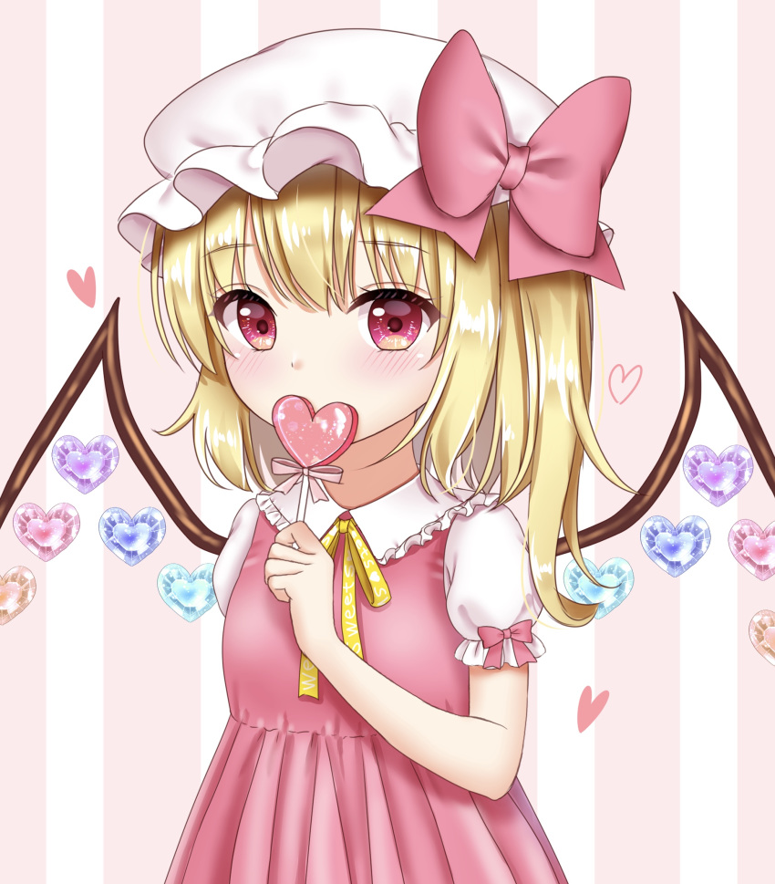 1girl alternate_color alternate_costume arm_up blonde_hair blush candy clothes_writing commentary_request covering_mouth dress english_text eyebrows_visible_through_hair flandre_scarlet food frilled_shirt_collar frills hair_between_eyes hat hat_ribbon heart highres holding_candy lollipop looking_at_viewer mob_cap nyanyanoruru one_side_up pinafore_dress pink_background pink_dress puffy_short_sleeves puffy_sleeves red_eyes ribbon shiny shiny_hair short_hair short_sleeves solo standing striped striped_background touhou upper_body vertical-striped_background vertical_stripes white_headwear wings yellow_neckwear yellow_ribbon