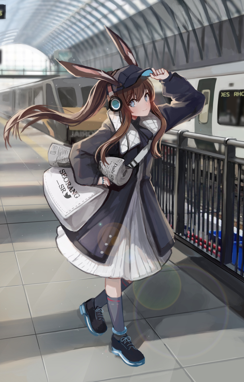 1girl absurdres adjusting_clothes adjusting_hat alternate_costume amiya_(arknights) animal_ears arknights arm_up bag bangs baseball_cap black_footwear black_headwear black_jacket blue_eyes blush brown_hair bunny_ears commentary_request dress floating_hair grey_footwear ground_vehicle hair_between_eyes hat head_tilt headphones highres holding holding_newspaper jacket kneehighs lens_flare long_hair long_sleeves looking_at_viewer newspaper pn_pixi ponytail railing satchel shoes smile sneakers solo train train_station white_dress