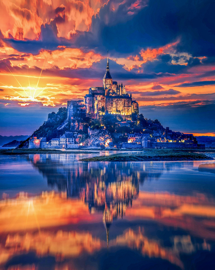 absurdres blue_clouds building castle cloud cloudy_sky colorful commentary_request france highres island lake leetius mont-saint-michel_(location) no_humans orange_sky original outdoors photorealistic real_world_location realistic reflection reflective_water scenery sky spire sun sunset water