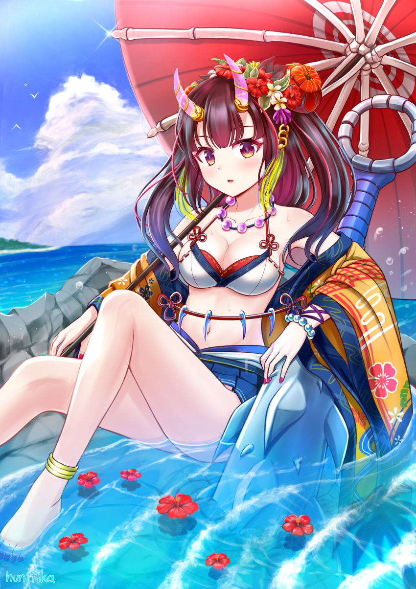 1girl artist_name bare_shoulders bikini bikini_skirt blurry blush breasts brown_eyes brown_hair cleavage cloud cloudy_sky club commentary_request day eyebrows_visible_through_hair hair_ornament highres horns jewelry knees_up long_hair looking_at_viewer medium_breasts necklace nichika_(nitikapo) ocean oni_horns open_mouth oriental_umbrella original partially_submerged petals petals_on_liquid red_hair red_nails sarong sitting sky solo swimsuit umbrella weapon wristband