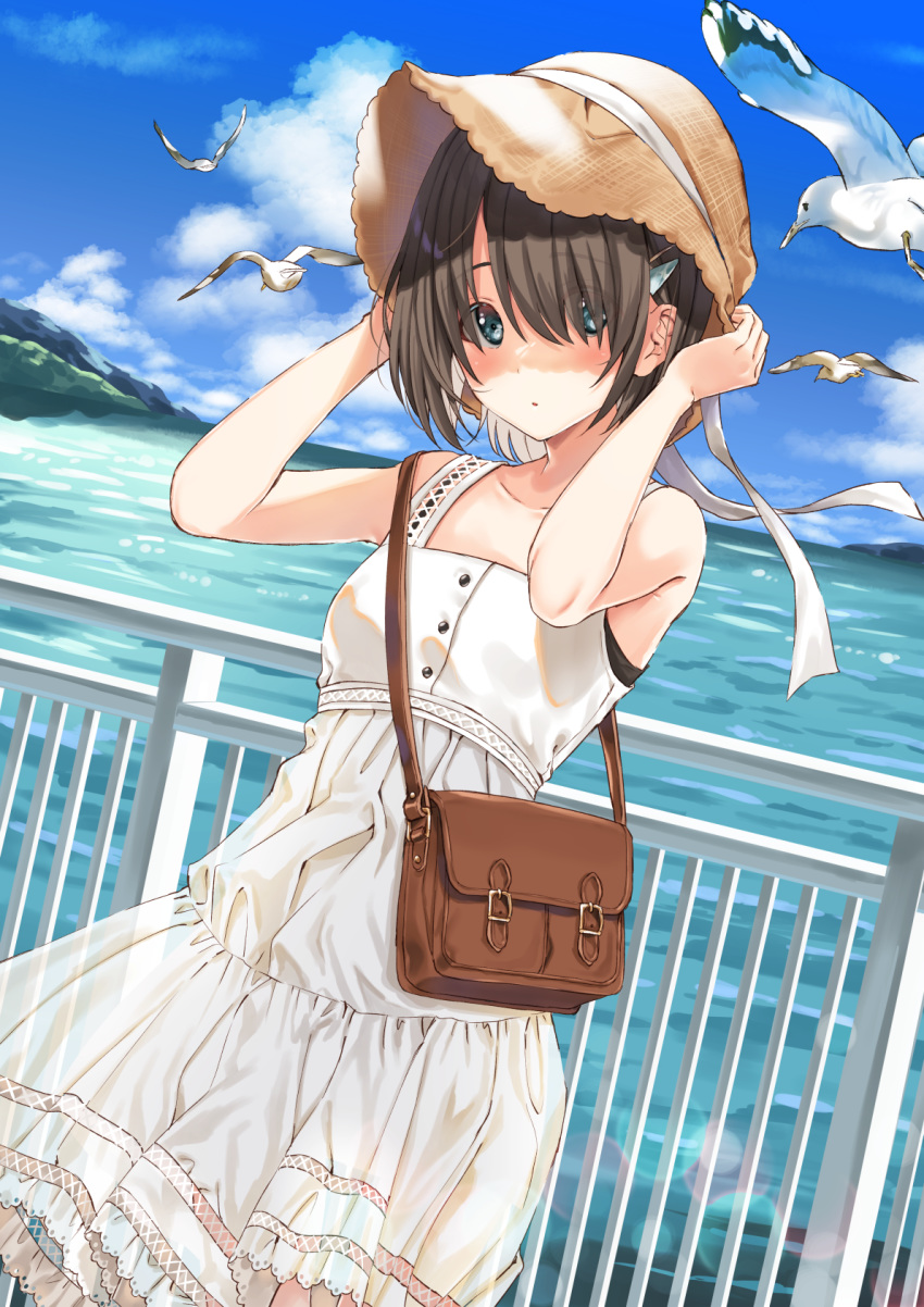 1girl :o adjusting_clothes adjusting_hat bag bird blue_eyes brown_hair cloud cowboy_shot dress eyebrows_visible_through_hair eyes_visible_through_hair hair_between_eyes hair_ornament hairclip hat highres kukiha mountain original railing ribbon seagull short_hair sky solo sun_hat sundress water white_dress white_ribbon